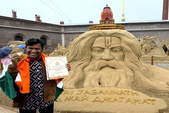 Indian Artist <span style="background-color:#fff9c4;font-weight:bold;">Sudarsan Pattnaik</span> Wins the <span style="background-color:#e2f0fb;font-weight:bold;">Russia Grand Sand Master Cup 2026</span>.